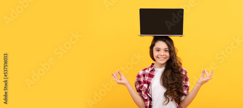 happy smart teen girl meditating with laptop on head presenting school online lesson, estudy. School girl portrait with laptop, horizontal poster. Banner header with copy space.