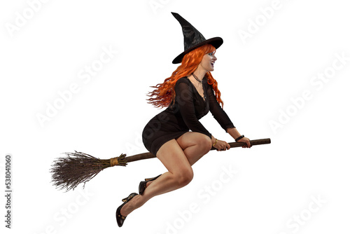 Halloween Witch flying on a broomstick. Female wizard fairy character for All Saints' Day. Fantasy gothic red-haired sorceress girl dressed in black carnival costume