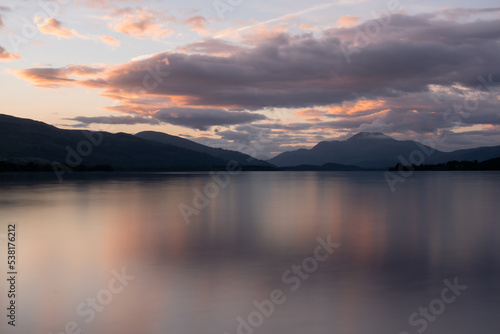 Beautiful sunset over Loch Lomond during late summer time with Ben Lomond standing high in the background