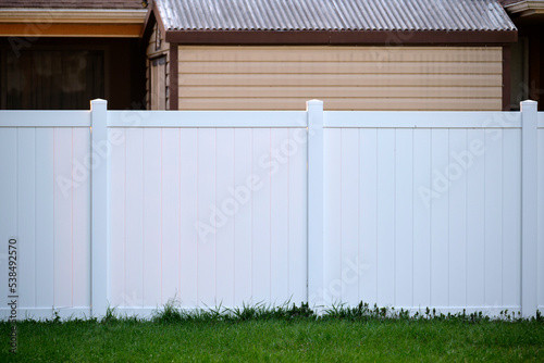 White plastic fence for back yard protection and privacy