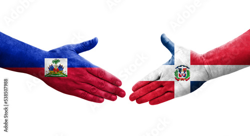 Handshake between Dominican Republic and Haiti flags painted on hands, isolated transparent image.