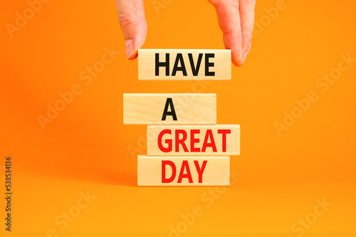 Have a great day symbol. Concept words Have a great day on wooden blocks. Beautiful orange table orange background. Businessman hand. Business, psychological Have a great day concept. Copy space.