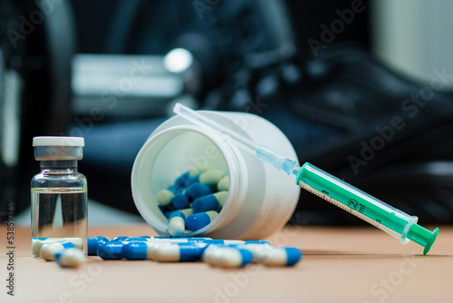 dumbbells, syringe with needle and vial with steroids. illegal doping in sport concept