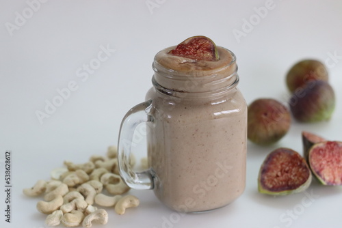 Fig Smoothie. Summer drink made of fresh fig in cashew milk, served in glass smoothie jar