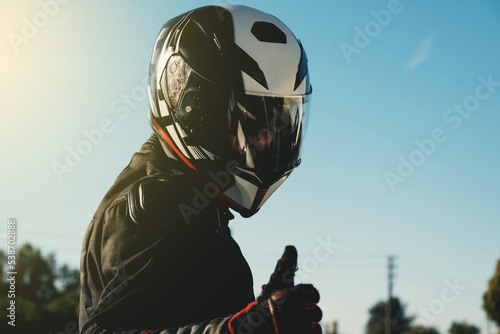 Portrait of a motorcycle rider with helmet.