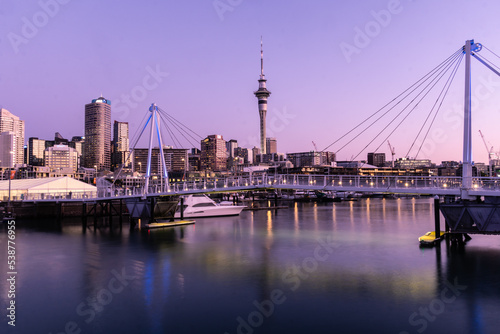 Auckland, New Zealand September 20 2021: The sun sets over the Viaduct marina and Auckland business district skyscrapers in New Zealand largest city
