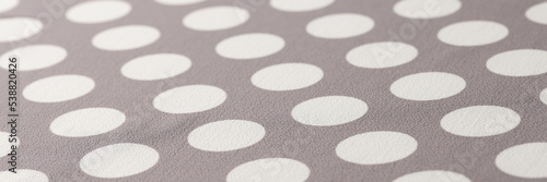 Seamless polka dots gray pattern closeup. Polka dot fabric
