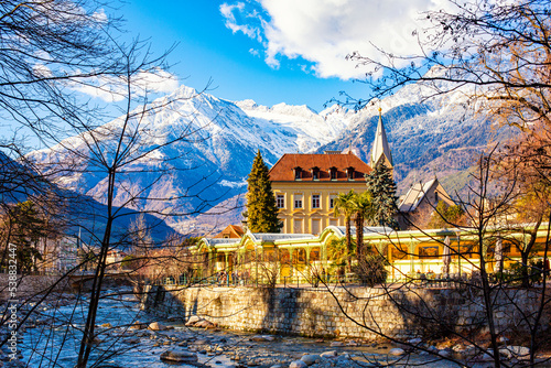 MERANO,ITALY - January 6, 2022. Merano o Meran is a city and comune in South Tyrol, northern Italy. Generally best known for its spa resorts. Passer River, Alps mountains in winter time.