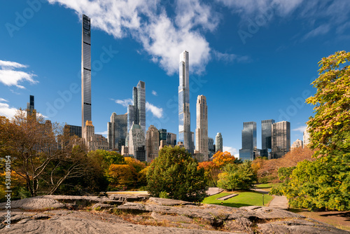 Central Park in Fall with view of the skyscrapers of Billionaires' Row in morning light. Midtown Manhattan, New York City