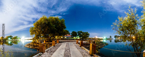 balcony in middle of a lake at night with some clouds in the sky and some stars, trees in island, laguna grande monte escobedo zacatecas 