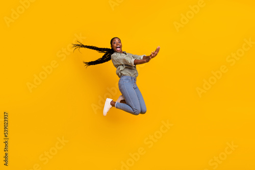 Full body photo of overjoyed active person have good mood jumping fall isolated on yellow color background