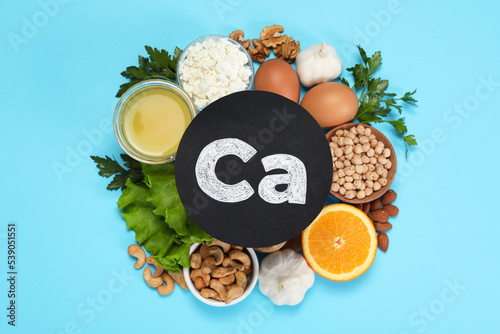 Food high in calcium. Flat lay composition with different products on light blue background