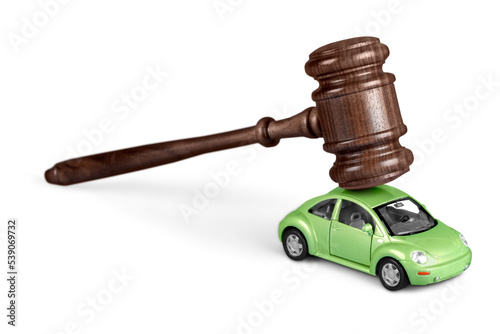 Wooden gavel with car on background