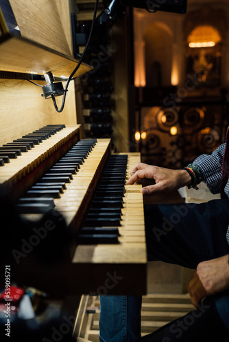 Close-up of a organist playing organ keyboard in church