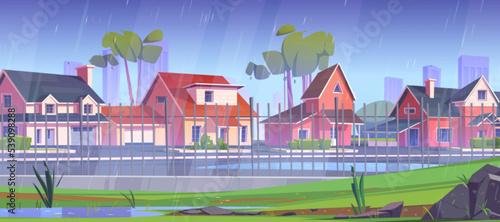 Suburban area at rain, street with cottage houses behind of metal fence with green trees, and puddles on road at rainy day. Countryside townscape with residential buildings Cartoon vector illustration