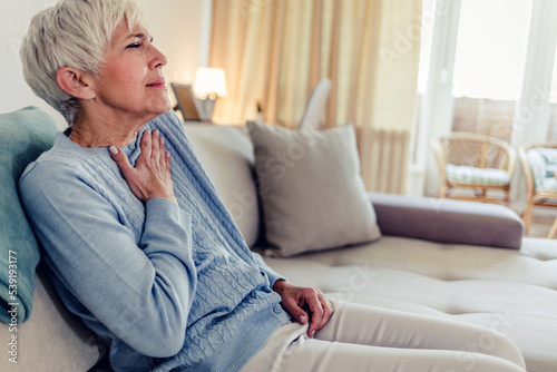 Female with chest pain. Senior woman suffering from heartburn or chest discomfort symptoms. Acid reflux or Gastroesophageal reflux disease (GERD) concept