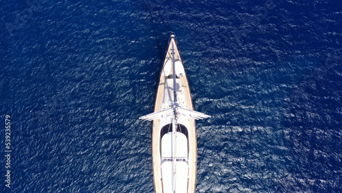 Aerial drone photo of beautiful sail boat anchored in deep blue open ocean sea
