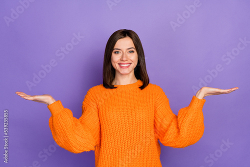 Photo portrait of nice young lady palms scales compare product dressed stylish knitted orange outfit isolated on purple color background