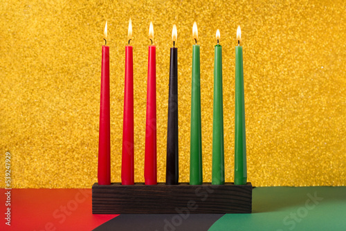 African American Kwanzaa holiday concept with traditional lit candles on symbolic background