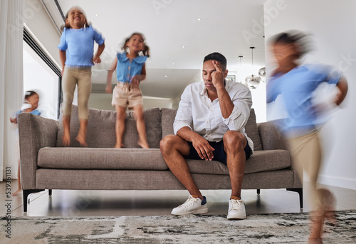Stress, headache and father with adhd kids running, jumping and playing in family home or house living room. Mental health, burnout or anxiety for parent with autism, energy and hyper active children