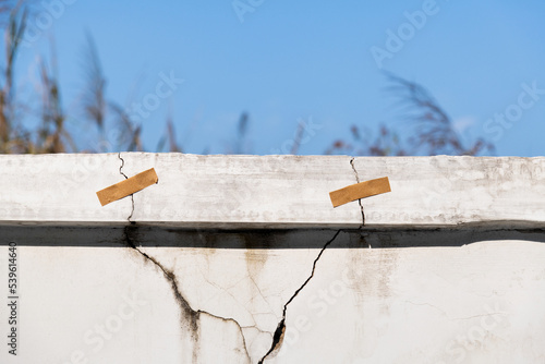 Cracked concrete parapet with adhesive