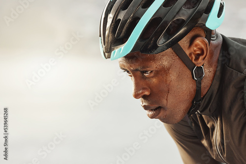 Cyclist man, sweating and focus for marathon race, competition or sports event on sky mock up for advertising space or marketing. Cycling sports person in helmet tired for training fitness challenge