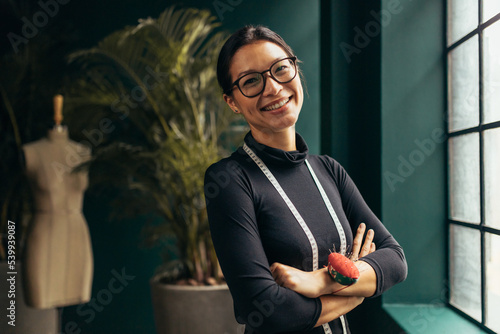 Young female designer smiling at camera