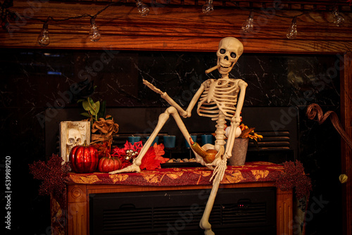 Skeleton getting ready to smoke a joint while sporting a gourd for a boner in his Halloween costume