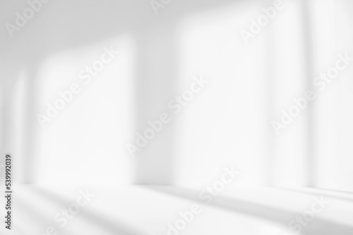 Blurred abstract white studio background for product presentation. Empty room with shadows of window. Display product.