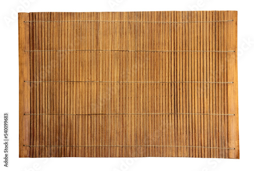 Brown bamboo food mat on wooden table.