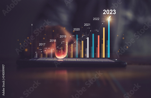 Businessman analyzes performance profitability of working companies with digital augmented reality graphics, positive indicators in 2023, businessman calculates financial data for long-term investment