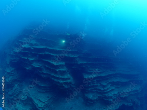 underwater scenery with strange rocks scuba divers around ocean scenery landscape topography underwater mediterranean