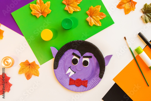 Cuts of paper for Halloween. Hand cut paper. Colors, scissors and glue. On a light background. Top view. Flat lay. DIY. Step by step.