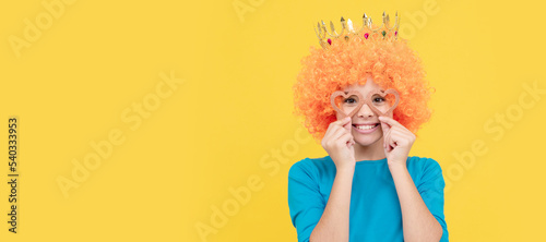 pure happiness. fancy party look. egocentric kid in clown wig and crown. Funny teenager child in wig, party poster. Banner header, copy space.