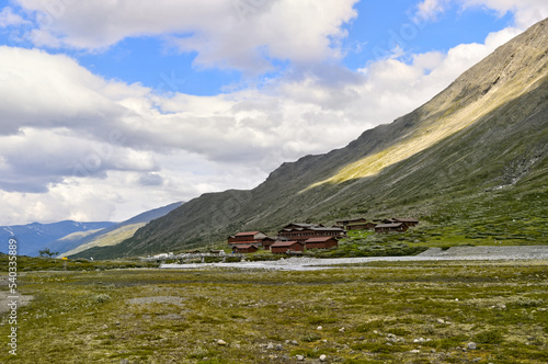 Galdhopiggen, Norway - Small wooden cabins as tourist accommodation high in the mountains in a valley in Norway.