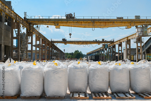 Big bags with calcium carbonate in yard of production plant