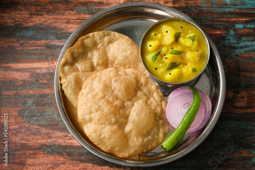 Puri Bhaji North Indian Poori with aalu bhaji , aalu sabji potato spicy recipe breakfast food a deep fried bread of whole wheat flour. poori masala in restaurant Kerala, India, Sri Lanka.