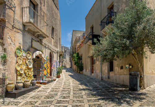 Erice, Sicily, Italy - July 10, 2020: Sicilian souvenirs. Ancient, typical narrow and cobblestone street in Erice, Sicily, Italy