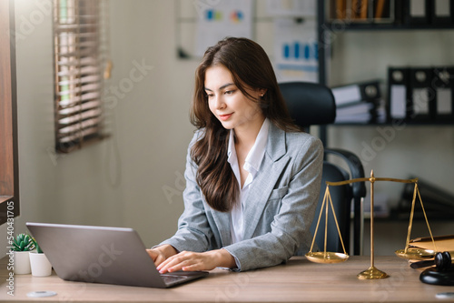 Beautiful asian woman lawyer working and gavel, tablet, laptop in front, Advice justice and law concept..