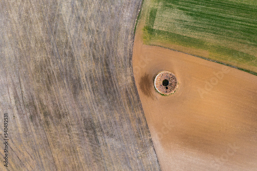 Aerial view of round dovecote in a rural field