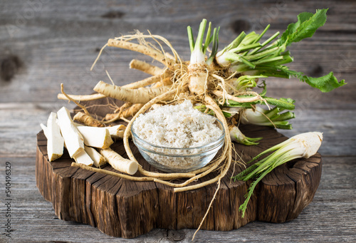 Fresh organic horseradishes on the wooden table