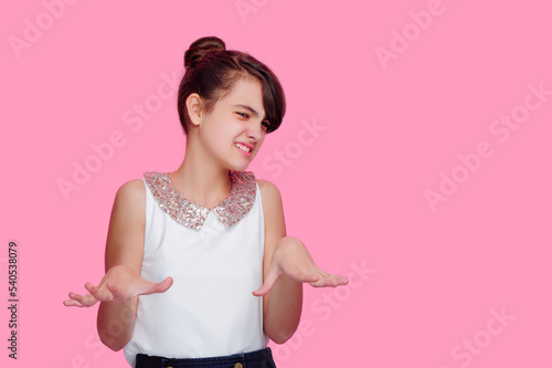 Brunette girl expressing disgust isolated on pink
