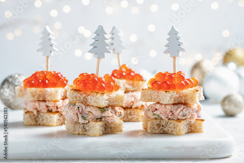 Christmas tree canape with Smoked Salmon, Cream Cheese, Dill, Horseradish Pate and red caviar for festive xmas snack