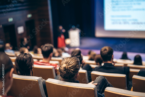 Woman giving presentation on business conference event.