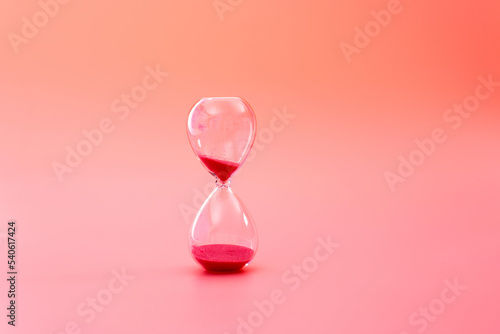 A hourglass on red background