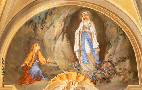 COURMAYEUR, ITALY - JULY 12, 2022: The fresco of apparition of Virgin Mary in Lourdes in church Chiesa di San Pantaleone by Nino Pirlato (1957).