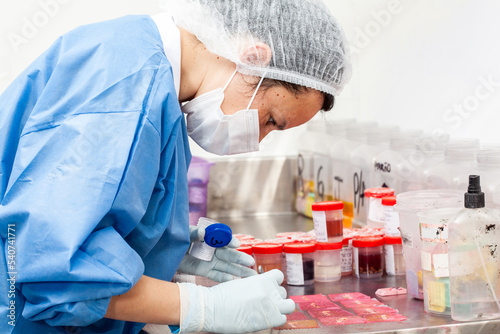 Scientist processing biopsy samples at the pathology laboratory to be embedded in paraffin for analysis. Cancer diagnosis concept. Medical concept.