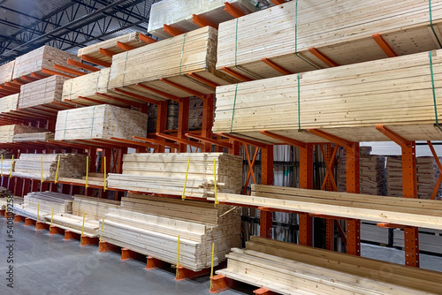 Wood factory stock or timber in warehouse. Piles of wooden boards waiting for shipping. Lumber, Business, production, manufacture and woodworking industry concept