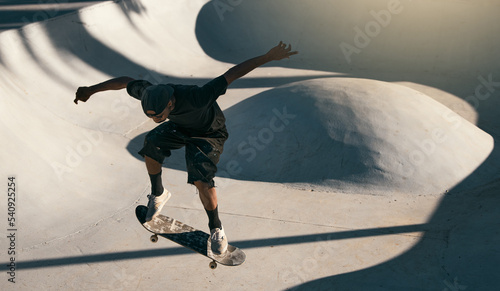 Man, skater and skateboard at park in air, trick or jump on ramp with speed, technique and sport. Skateboarder, action and concrete at event, game or contest with shoes in summer, sunshine or outdoor