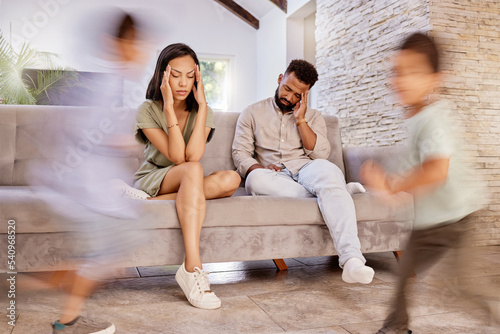 Sofa, family and tired with fast children running with speed in living room of house together. Fatigue, exhausted or headache of young parents at home in Mexico with busy adhd or hyper kids.